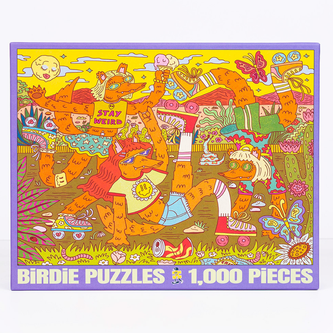 A square jigsaw puzzle box featuring a colorful psychedelic illustration of cartoon fox characters in a grassy scene, with the text 'BIRDIE PUZZLES 1,000 PIECES' along the bottom.