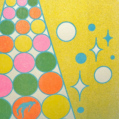 Colorful patterned paper with circles and stars on a yellow background