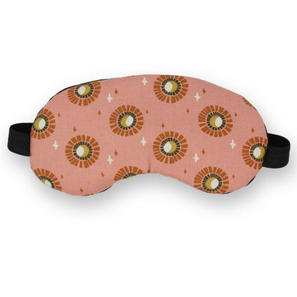 Sleep mask with abstract sun pattern on a white background