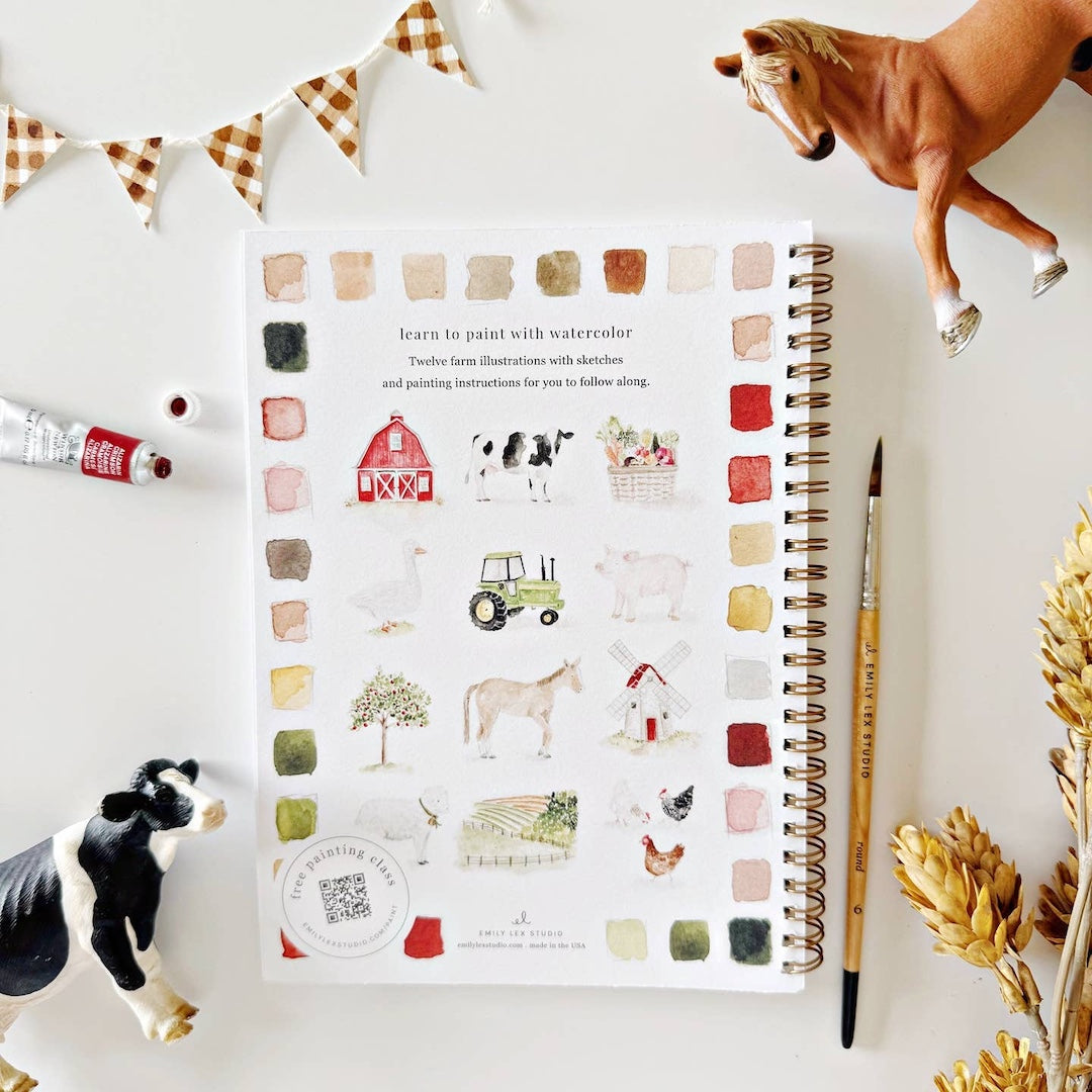 Notebook with farm-themed illustrations on a white surface with decorative elements.