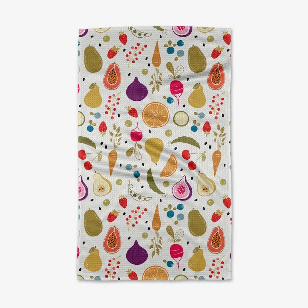 white dishtowel with a variety of fruits and vegetables on it