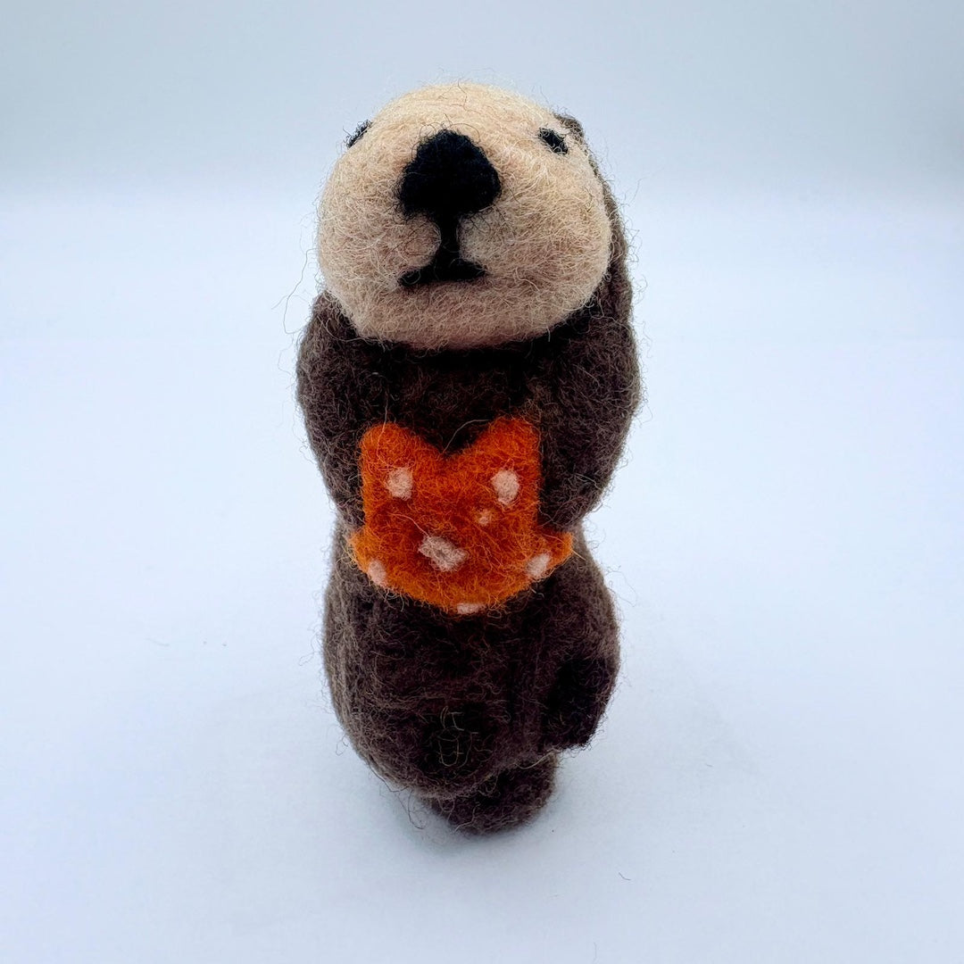 Felt otter holding an orange sea star