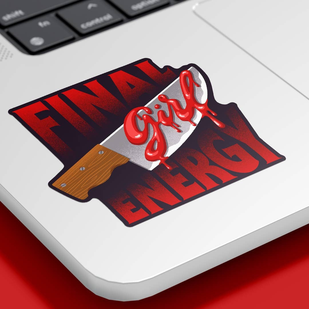 A die-cut sticker featuring the text 'FINAL Girl ENERGY' in red and black, with a bloody knife graphic, shown applied to the corner of a silver laptop on a red surface.