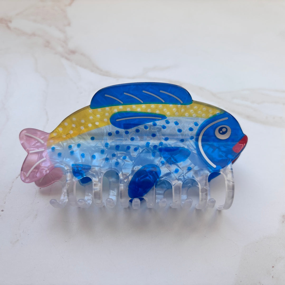 Fish-shaped hair clip with blue and yellow design on a white background
