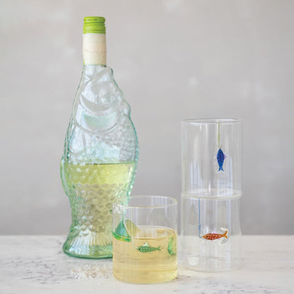Bottle and glasses with fish illustrations on a light gray background