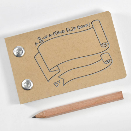 A Kraft brown flip book with embossed scroll artwork and two metal snap buttons, shown on a white background with a wooden pencil beside it.