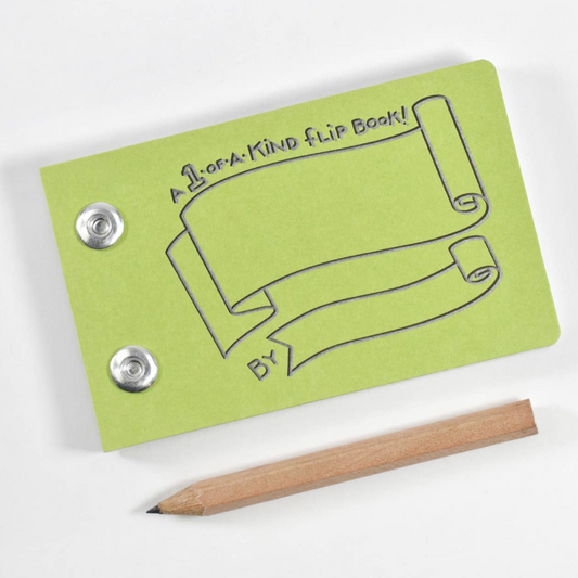 Green flip book with embossed scroll artwork and two metal snap buttons, shown on a white background with a wooden pencil beside it.
