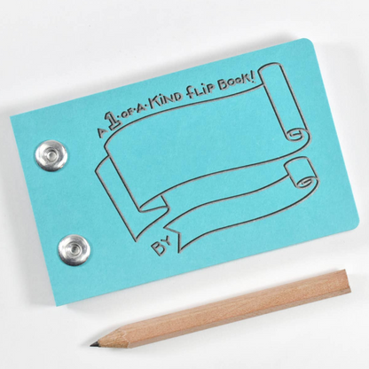 A blue flip book with embossed scroll artwork and two metal snap buttons, shown on a white background with a wooden pencil beside it.