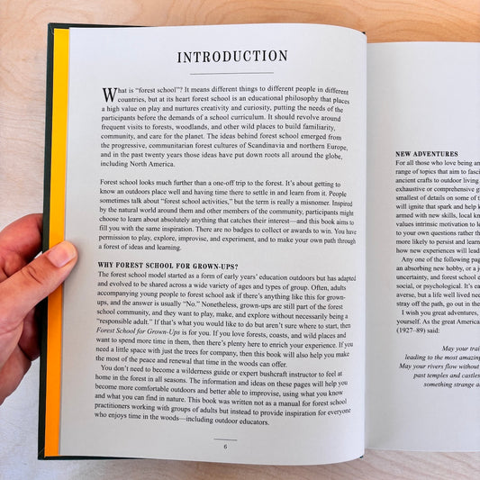 An open book showing the 'Introduction' page from its front cover, photographed against a dark background. The page has black text on a white background 
