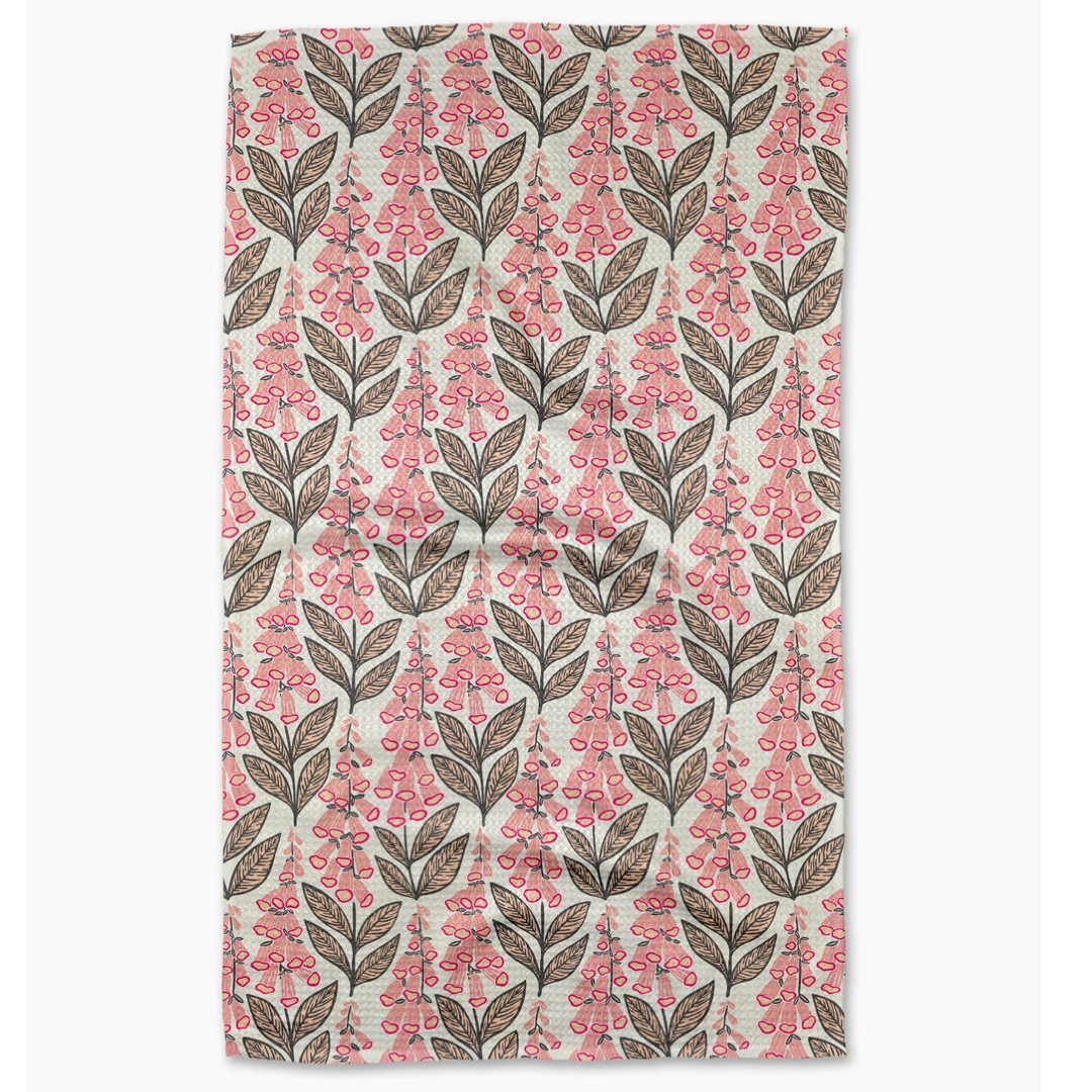 Floral patterned towel with pink flowers and brown leaves on a white background