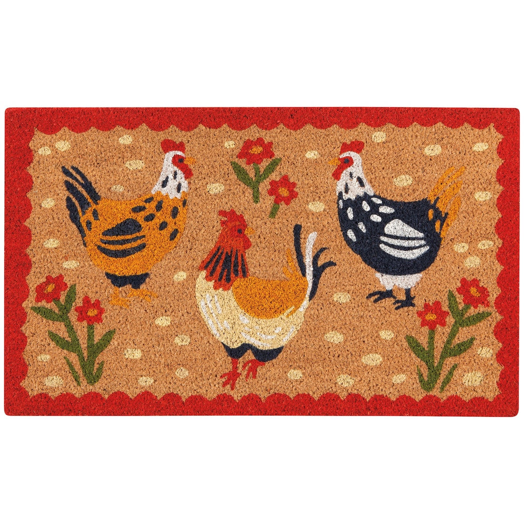 A rectangular coir doormat featuring three stylized chickens in orange, black, white, and red, surrounded by red flowers and green stems on a tan background with a red scalloped border.