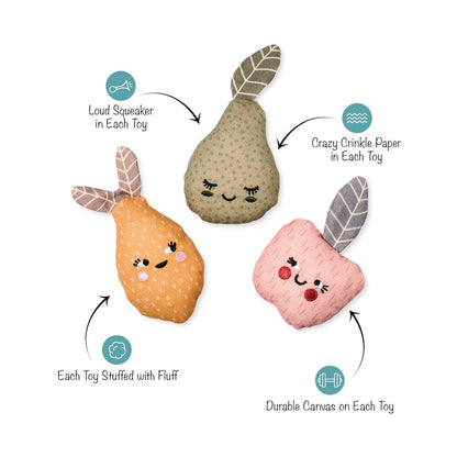 Three plush puffer toys shaped like fruit, shown on a white background with callout arrows and text describing features: one pear in beige with green spots, one orange pear with pink cheeks, and one pink apple with red cheeks. Teal icons and labels mention loud squeaker, crazy crinkle paper, stuffed with fluff, and durable canvas.