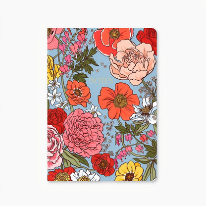 Notebook with a light blue background and a floral design that features pink, red, white, and yellow flowers; on the center of the notebooks "Notes" is written in gold. Shown on a white background