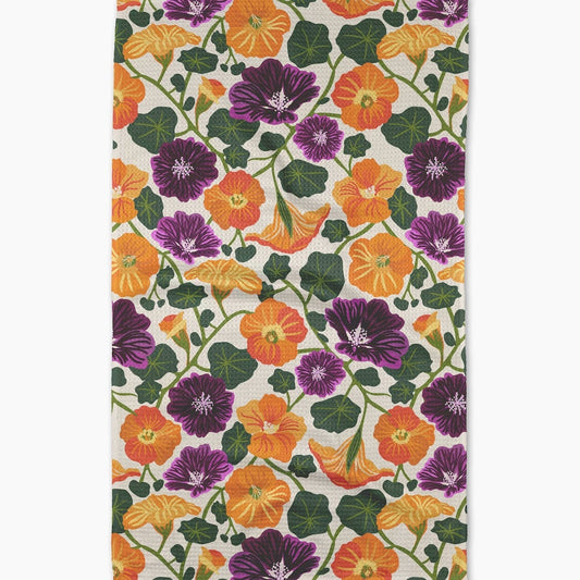 Floral patterned fabric with orange, purple, and green flowers on a white background