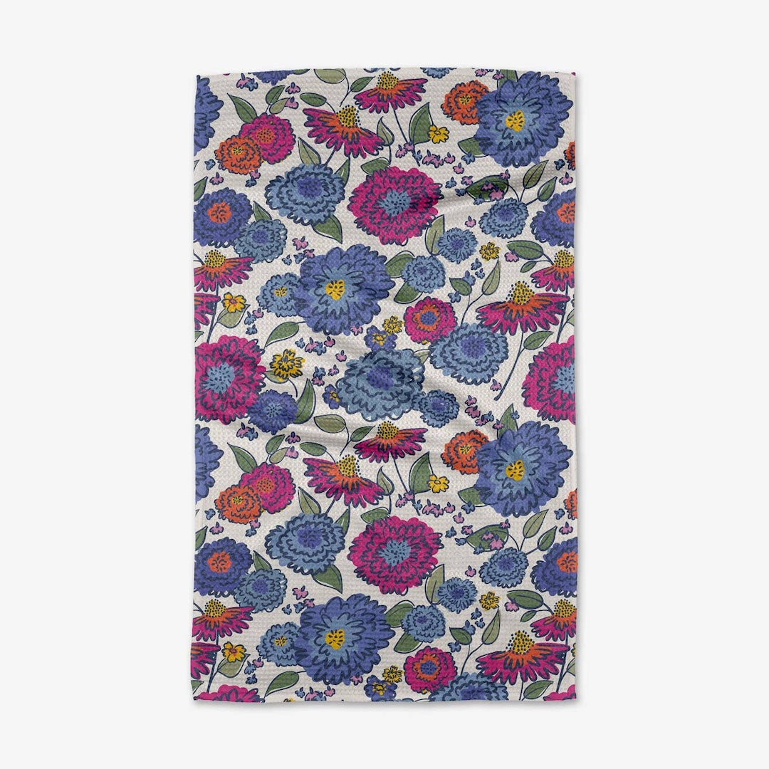 Floral patterned towel with blue, pink, and purple flowers on a white background