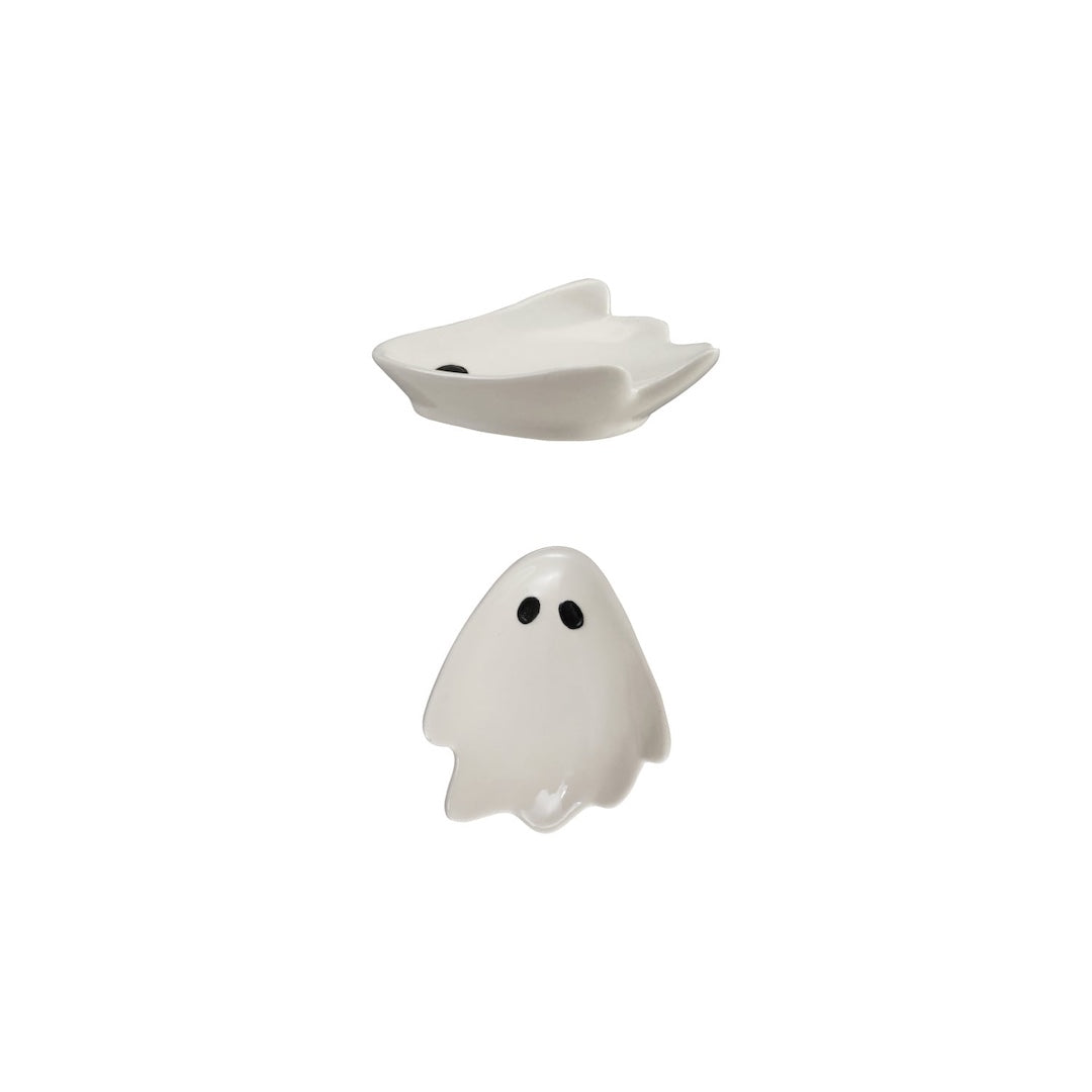 Two small ghost-shaped ceramic dishes with black eyes, shown on a plain white background.