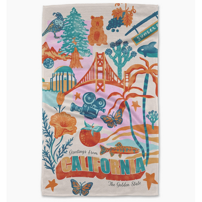 Colorful towel with California-themed designs including the Golden Gate Bridge and beach elements.