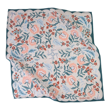 A bandana featuring a hand-drawn style floral pattern in coral pink, rust red, and light blue on a cream background, finished with a dark teal border.