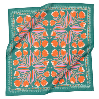 Floral patterned fabric with orange flowers on a green background