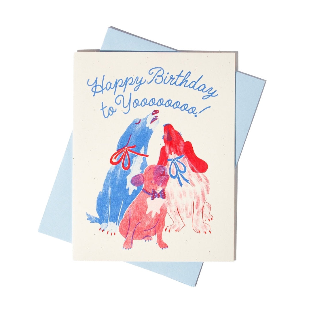 Birthday card with colorful illustrations of dogs and text that reads "happy birthday to yoooooo!" on a white background