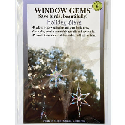 Window Gems 'Holiday Stars' suncatcher stickers in its clear plastic packaging, featuring a white and lavender label with product details and a demonstration photo of iridescent star decals.