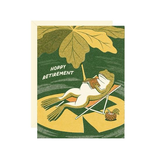 Greeting card with a frog on a lounge chair under a leaf, text 'Hoppy Retirement'.