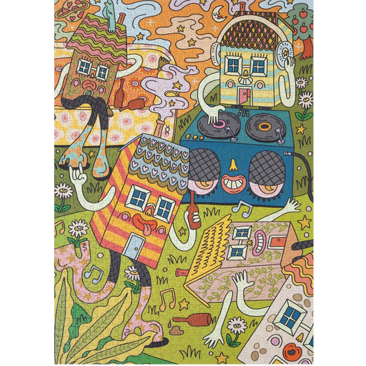 A colorful jigsaw puzzle featuring a whimsical illustration with stylized houses, faces, hands, stars, and abstract shapes in a playful doodle-like style on a green ground.