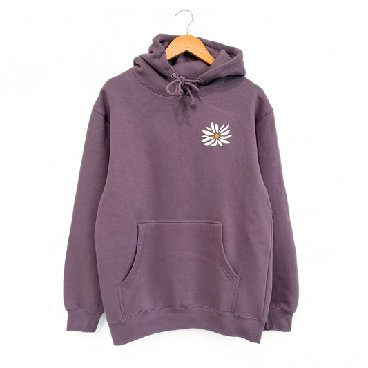 Purple hoodie with a white flower design on a hanger against a white background