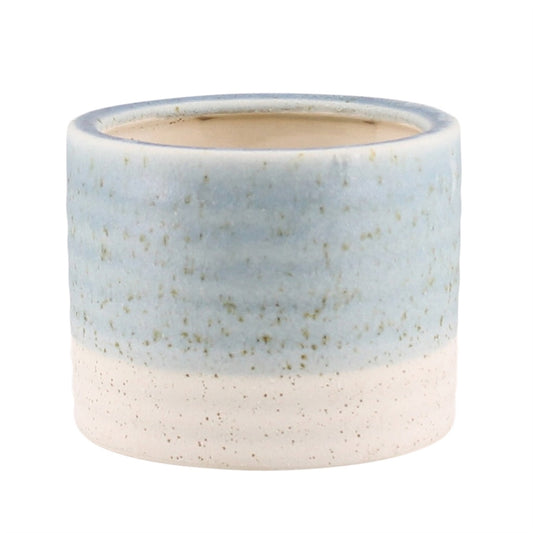 A small cylindrical ceramic planter with a two-tone glaze, featuring a light blue upper section and a speckled off-white lower section, shown on a plain white background.