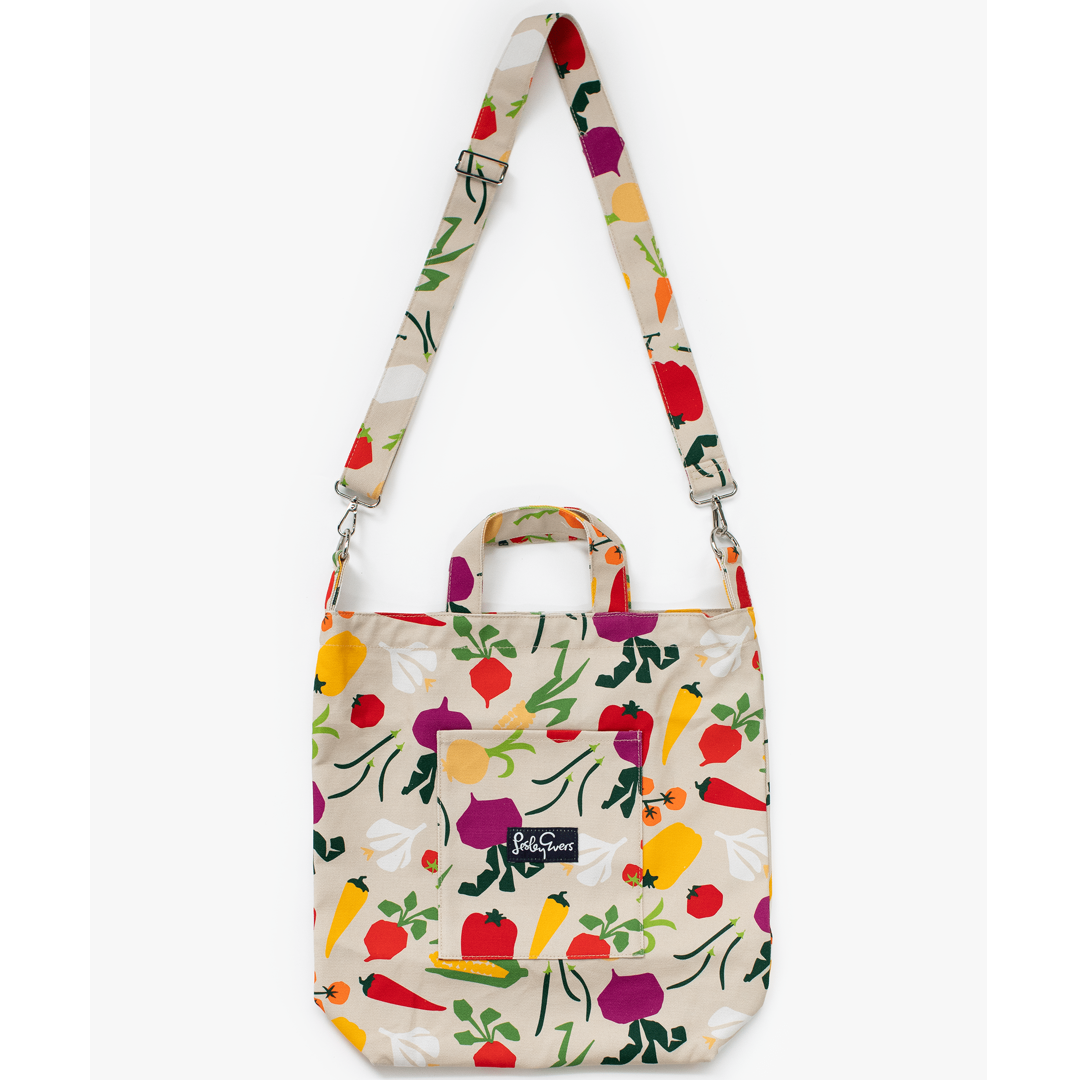 Tote bag with colorful vegetable pattern on a beige background