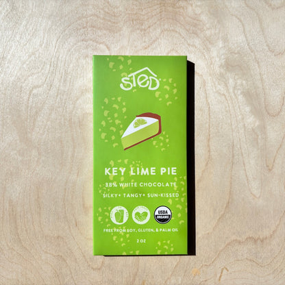 STED key lime pie chocolate bar in packaging on a wooden surface