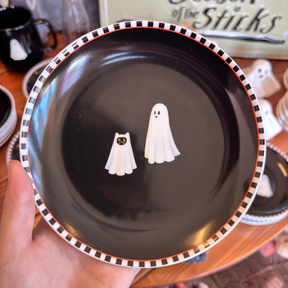 round black plate with a ghost and a cat under a sheet looking like a ghost 