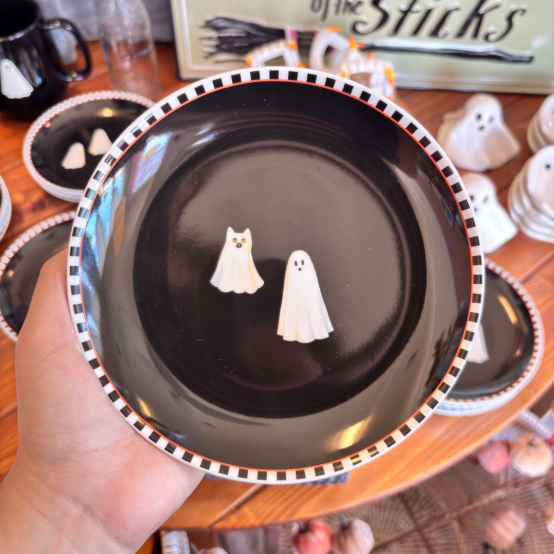 round black plate with a ghost and a cat under a sheet looking like a ghist