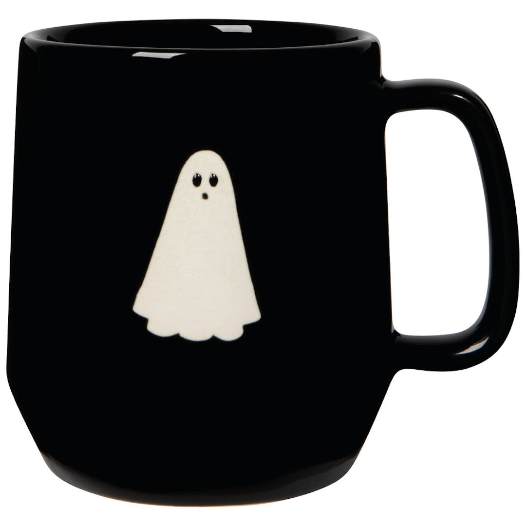 Black mug with a white ghost design on a white background