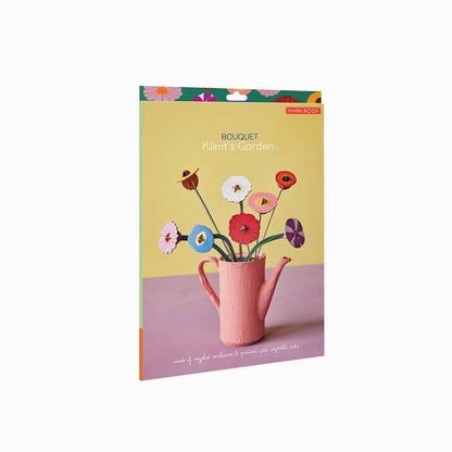box with a design of flowers in a pink teapot can on a yellow background