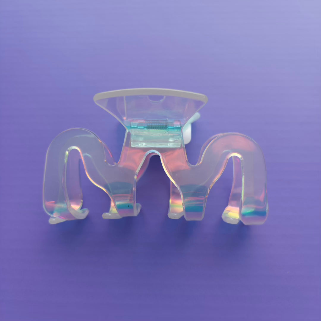 iridescent claw clip on a purple background