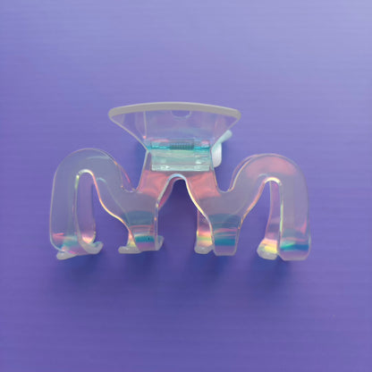 iridescent claw clip on a purple background