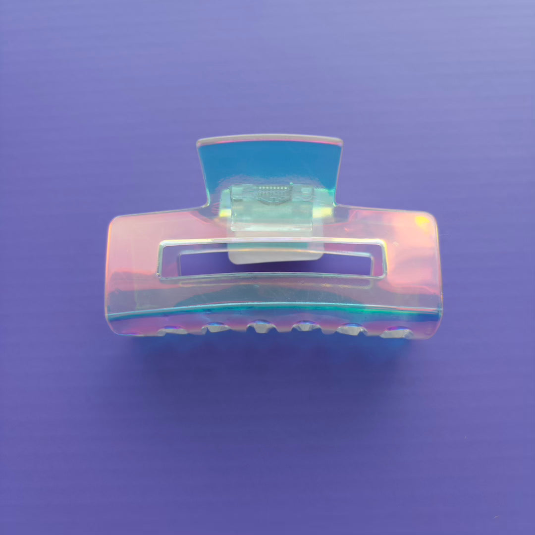 Iridescent hair clip on a purple background