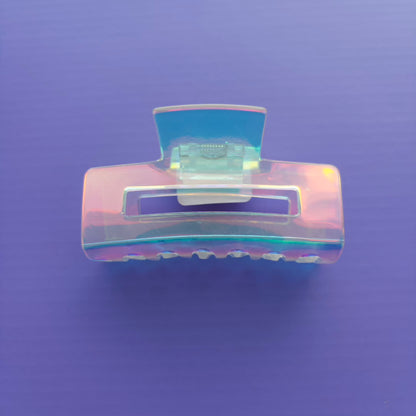 Iridescent hair clip on a purple background
