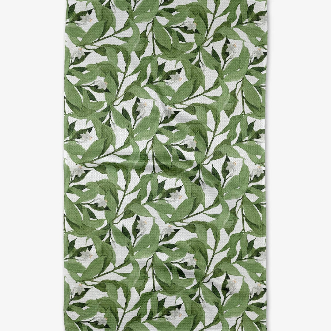 dishtowel with a green leaf pattern on a white background