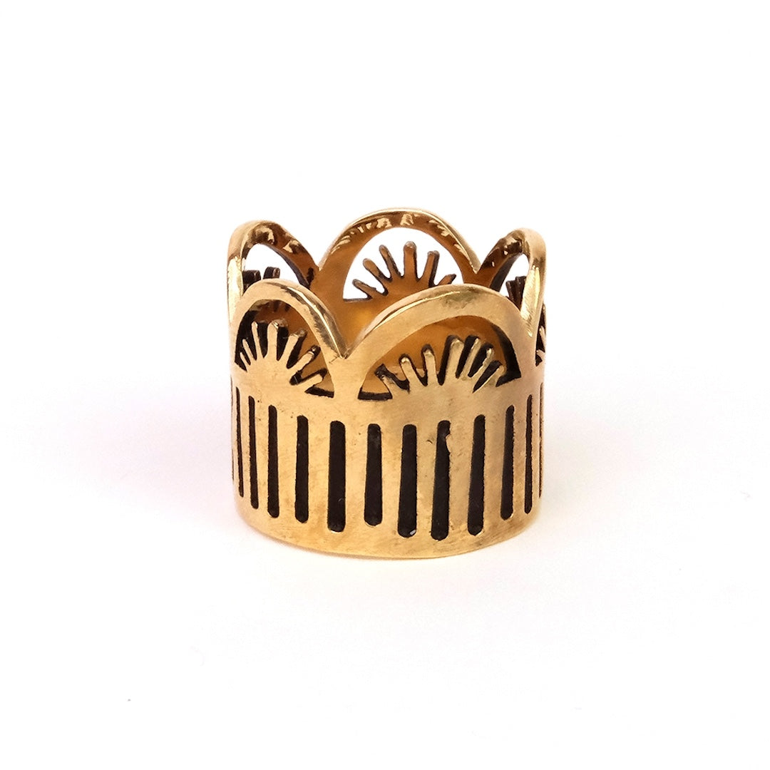 Brass bandana slide ring with intricate design on a white background