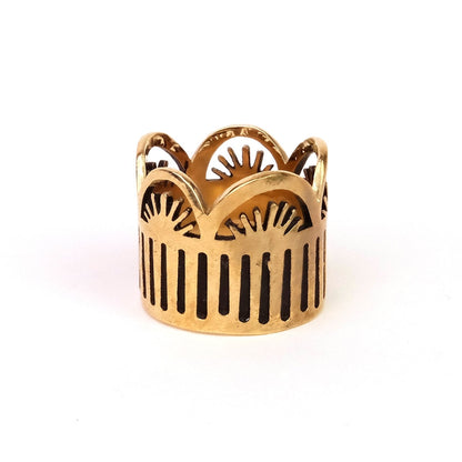 Brass bandana slide ring with intricate design on a white background