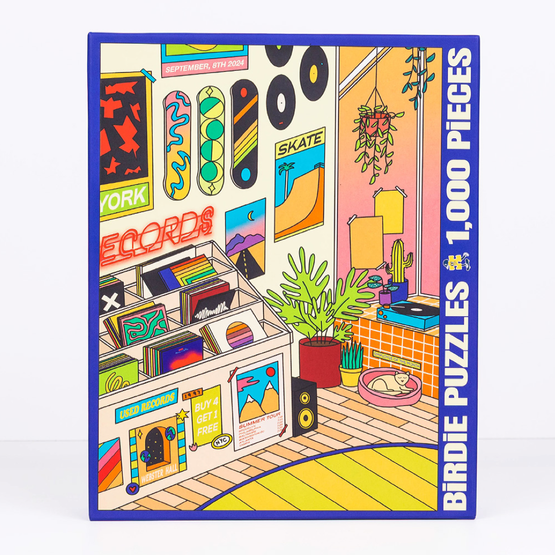 A 1,000-piece jigsaw puzzle box by Birdie Puzzles, featuring a colorful retro-style illustration of a room with vinyl records, posters, plants, and a cat on a cushion.
