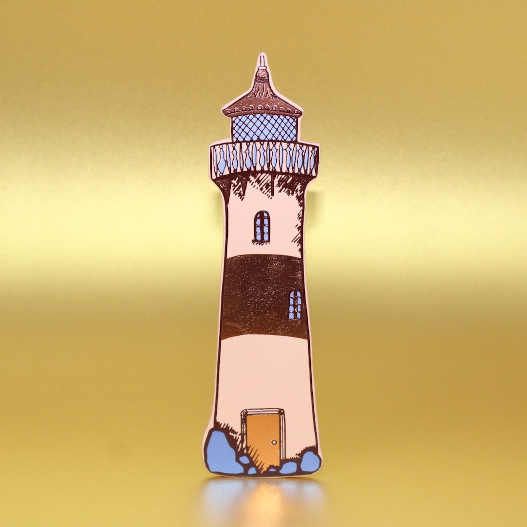 Lighthouse-shaped leather bookmark on a yellow background