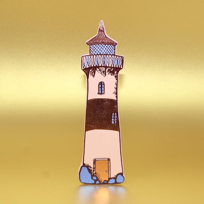Lighthouse-shaped leather bookmark on a yellow background