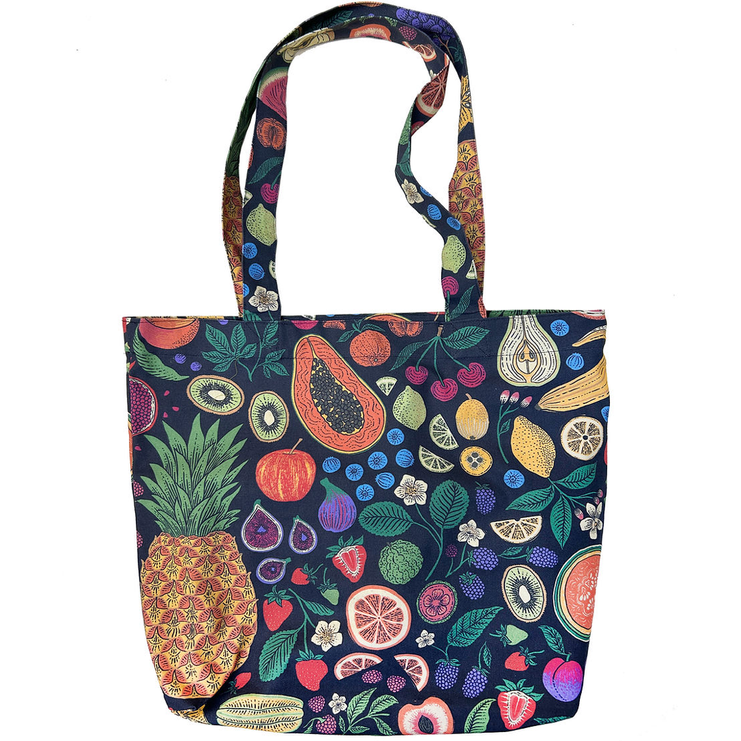 A fabric tote bag featuring a colorful, dense fruit and vegetable print on a dark navy background, complete with two shoulder straps, shown against a plain white background.