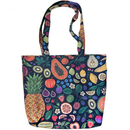 A fabric tote bag featuring a colorful, dense fruit and vegetable print on a dark navy background, complete with two shoulder straps, shown against a plain white background.