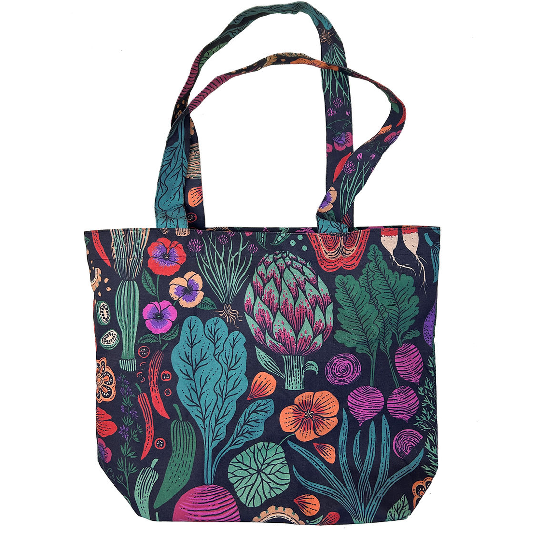 A canvas tote bag featuring a vibrant, multicolored botanical and mushroom print on a dark navy background, shown against a plain white background.