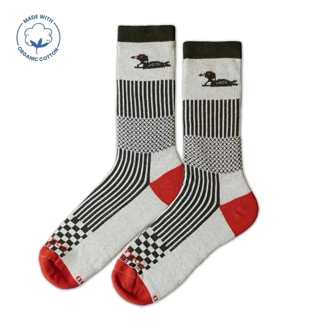 Pair of socks with a duck and a  black, white, and red pattern on a white background