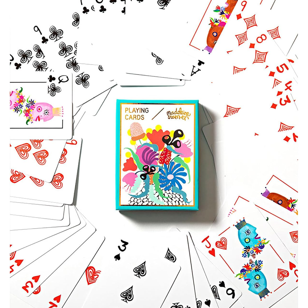 A colorful deck of playing cards labeled 'Playing Cards' arranged in a flat-lay on a white background, with several cards fanned out around the box.